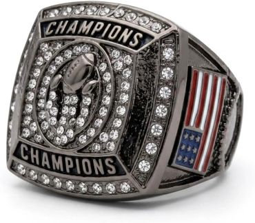 A championship ring with football and American flag design.