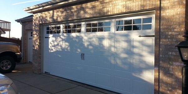 Insulated garage door with windows