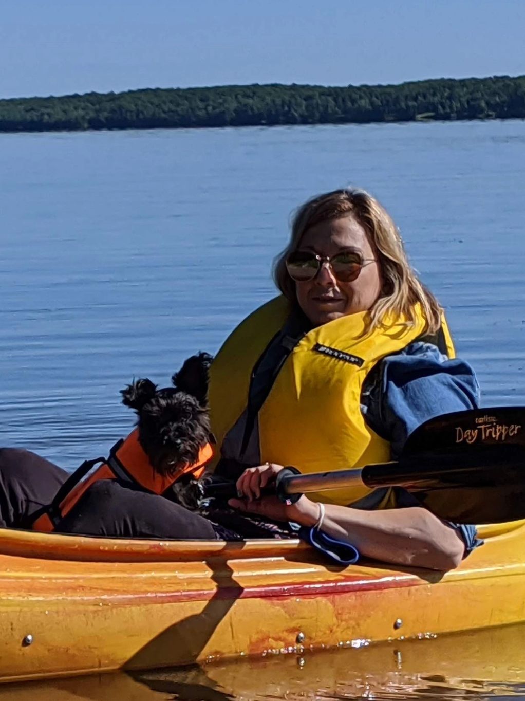 Woman and small dog in kayak.