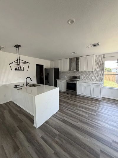 Premium modern kitchen remodel featuring high-end custom cabinetry and lighting design in Austin Tex