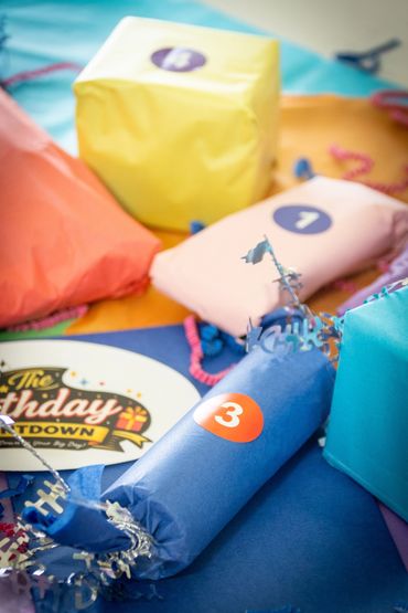 Numbered birthday countdown gifts wrapped and ready for daily birthday surprises.