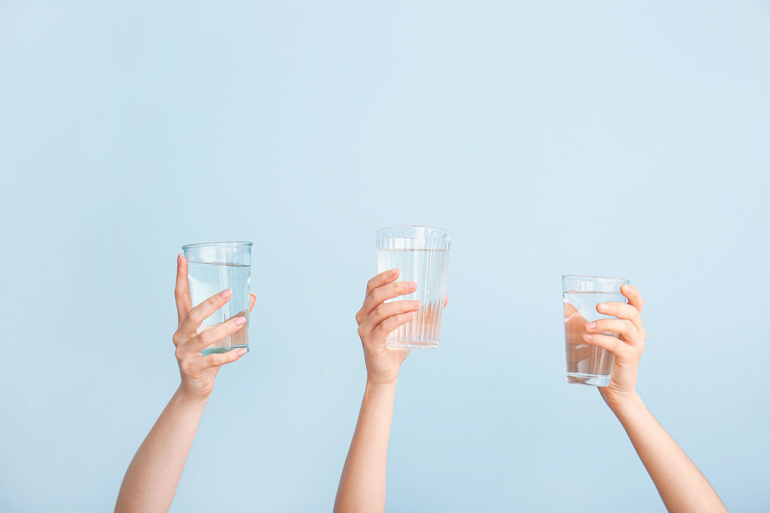Group of people raising a glass of water