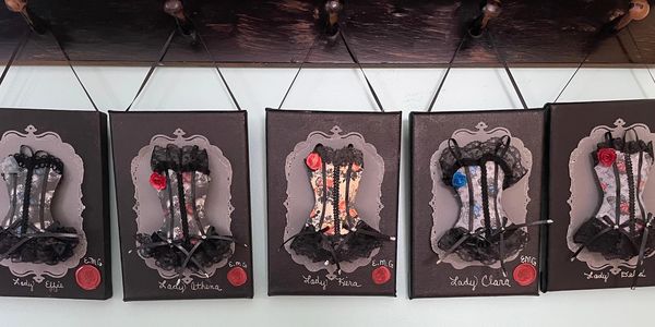 Handcrafted miniature paper corsets designed as elegant wall art, each mounted on 5x7 artist canvas.