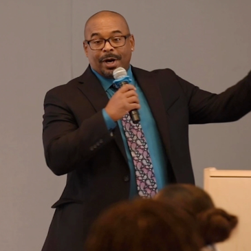 Confident man speaking to an audience.