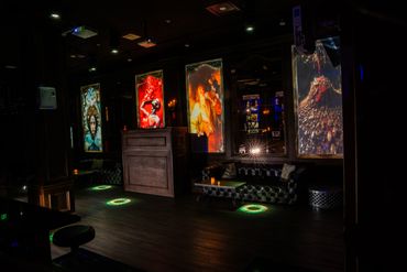 Dimly lit lounge with artistic backlit panels and cozy seating.