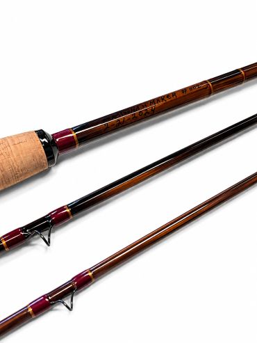 Close-up of a segmented fishing rod with wooden handle and maroon accents.