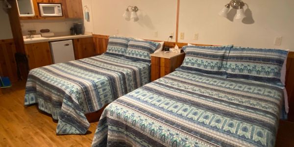 Two full size beds with boho bedspreads, and stocked kitchenette, in the Loft