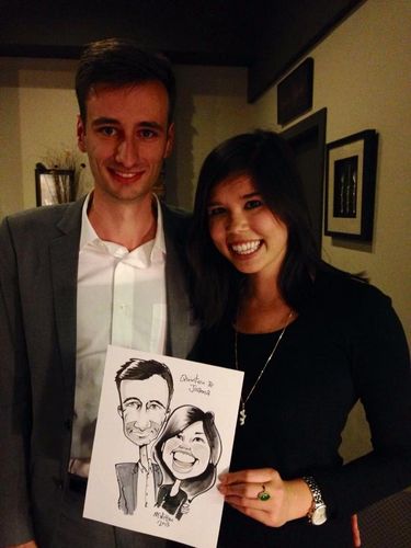 couple thrilled with getting caricature drawn by  McMillan at party. Office Christmas party caricatu