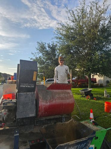 Crew member at the concrete mixing station on the work trailer.
