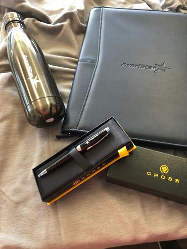 A set of AveriStar branded items including a water bottle, folder, and pen in a Cross box.