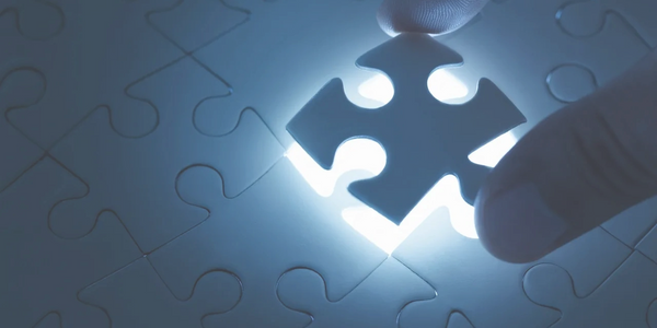 Puzzle with one piece elevated and the space illuminated