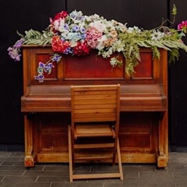 Piano with a flower spray