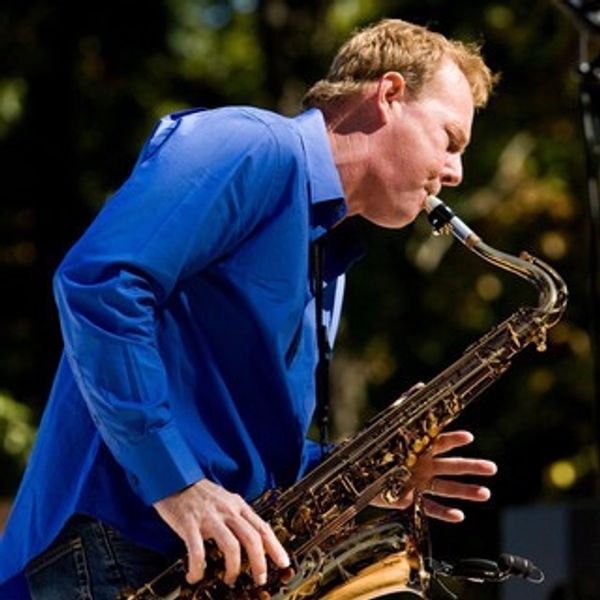 Man passionately playing a saxophone outdoors.