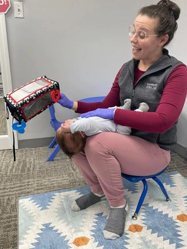 Ms. Caroline (OT, CLC) helping this little one release tension while in the guppy pose!