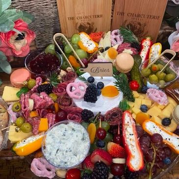 Colorful charcuterie board with cheeses, fruits, and snacks.