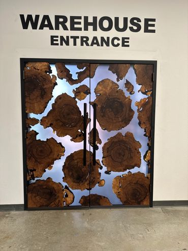 Warehouse entrance with unique wooden slice door design.
