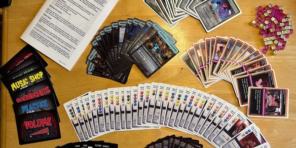 A tabletop card game setup with various colorful cards and tokens.