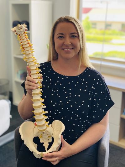 Dr Jennifer Martin Chiropractor at My Spine Chiropractic with a spine showing spinal nerves & discs