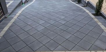 charcoal concrete driveway pavers laid in a diamond pattern, paving features header coarse pattern