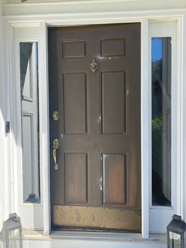 A close-up of the chocolate brown wooden door