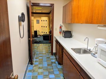 Kitchenette with sink and microwave.