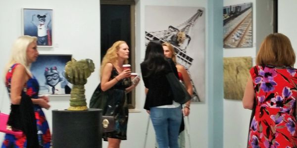 Group of guests enjoying an art exhibit at mindwarehouse