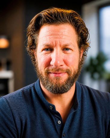 Smiling man with beard in a cozy indoor setting.