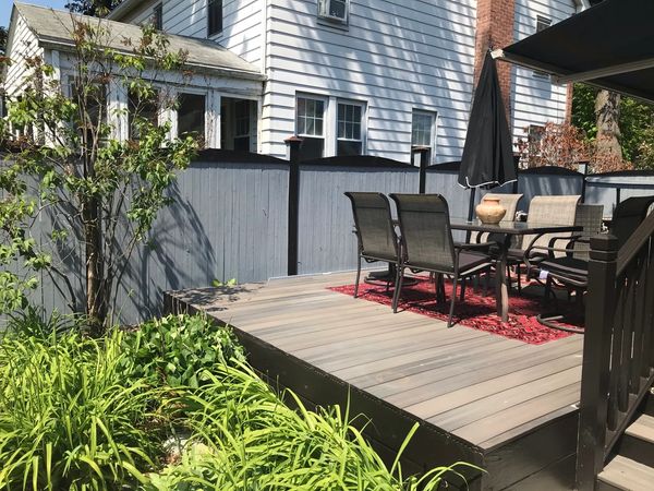 Outdoor living space with stained fence and painted posts caps & deck structure