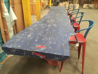 Huge 12 foot long live edge slab bar finished with rustic navy color accented by red bowtie joinery