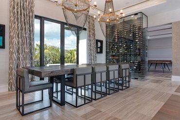 Luxury dining room with live edge slab table on Siesta Key in a char grey custom finish