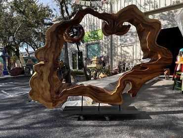 Amazing round live edge art slab is 9 foot diameter and mounted on modern iron base for display