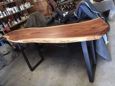 A beautifully crafted live edge slab bar table with a sleek and minimalist design,