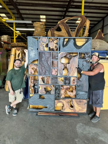 Decor Direct team members in warehouse showing off size of live edge slab art wall room divider