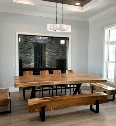 Luxury dining room by wine room with live edge slab table matching timber beam benched & slab chairs