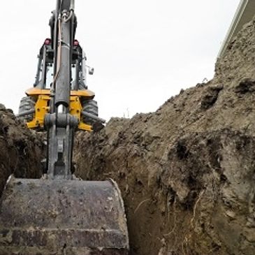 A Backhoe Excavating a Ditch