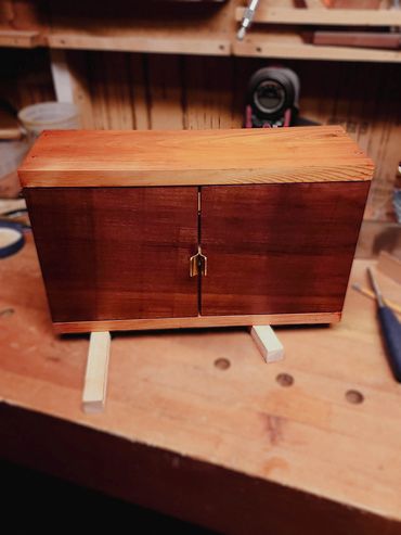 Custom small wooden cabinet.