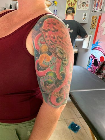 Colorful octopus tattoo on upper arm.