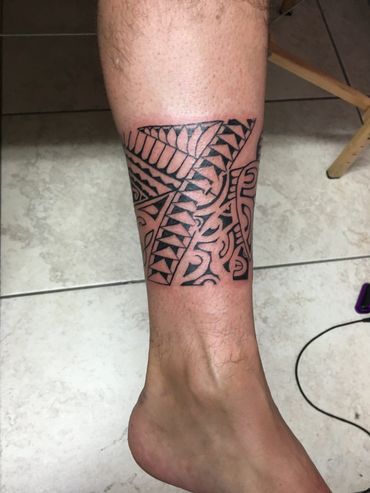 Tribal tattoo on lower leg.