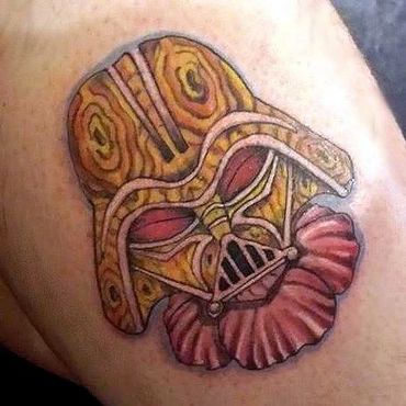 Tattoo of Darth Vader's helmet with a wooden texture and red collar.