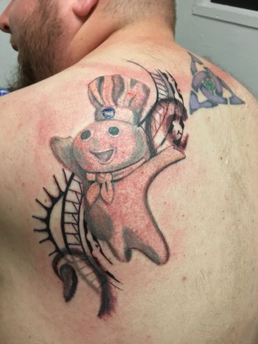 Colorful cartoon tattoo on a person's shoulder.
