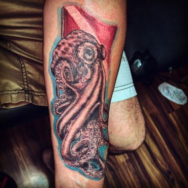 Colorful octopus tattoo on forearm.