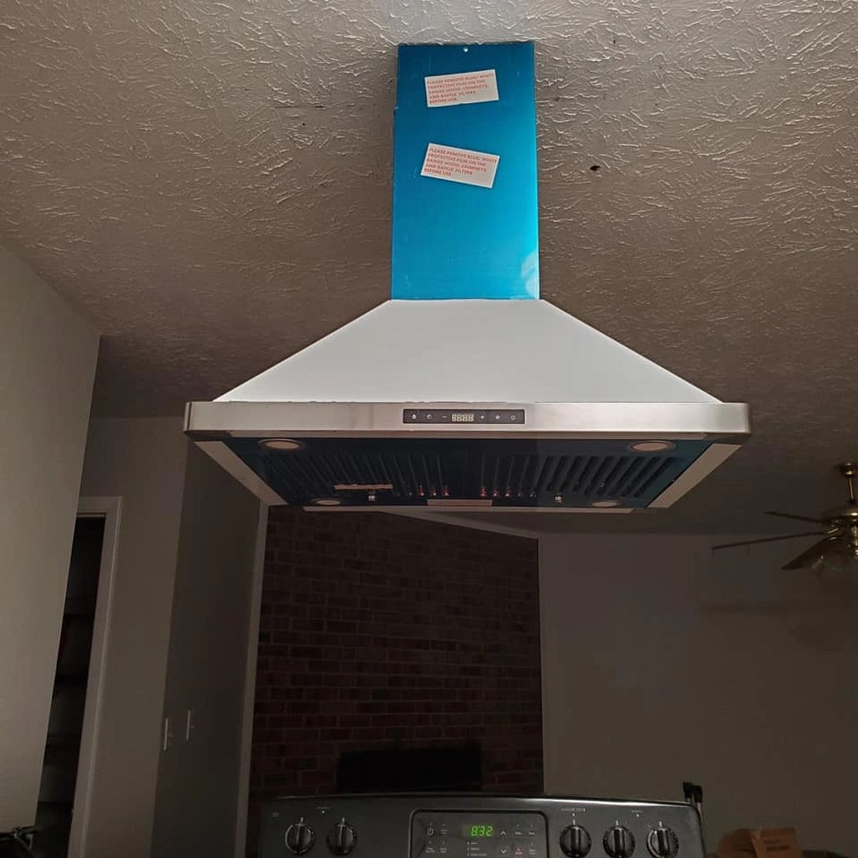 Stainless steel ductless hood vent installed.