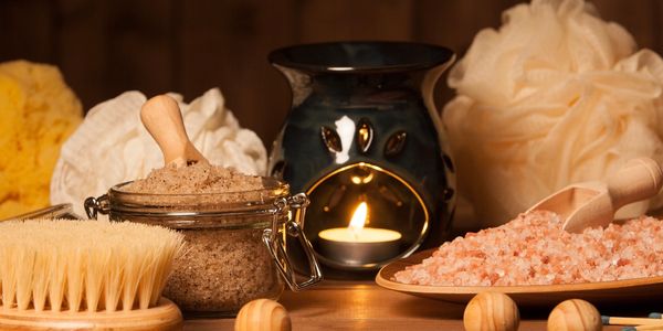 A massage room with candles, Himalayan Salt Stones and lymphatic drainage brush.