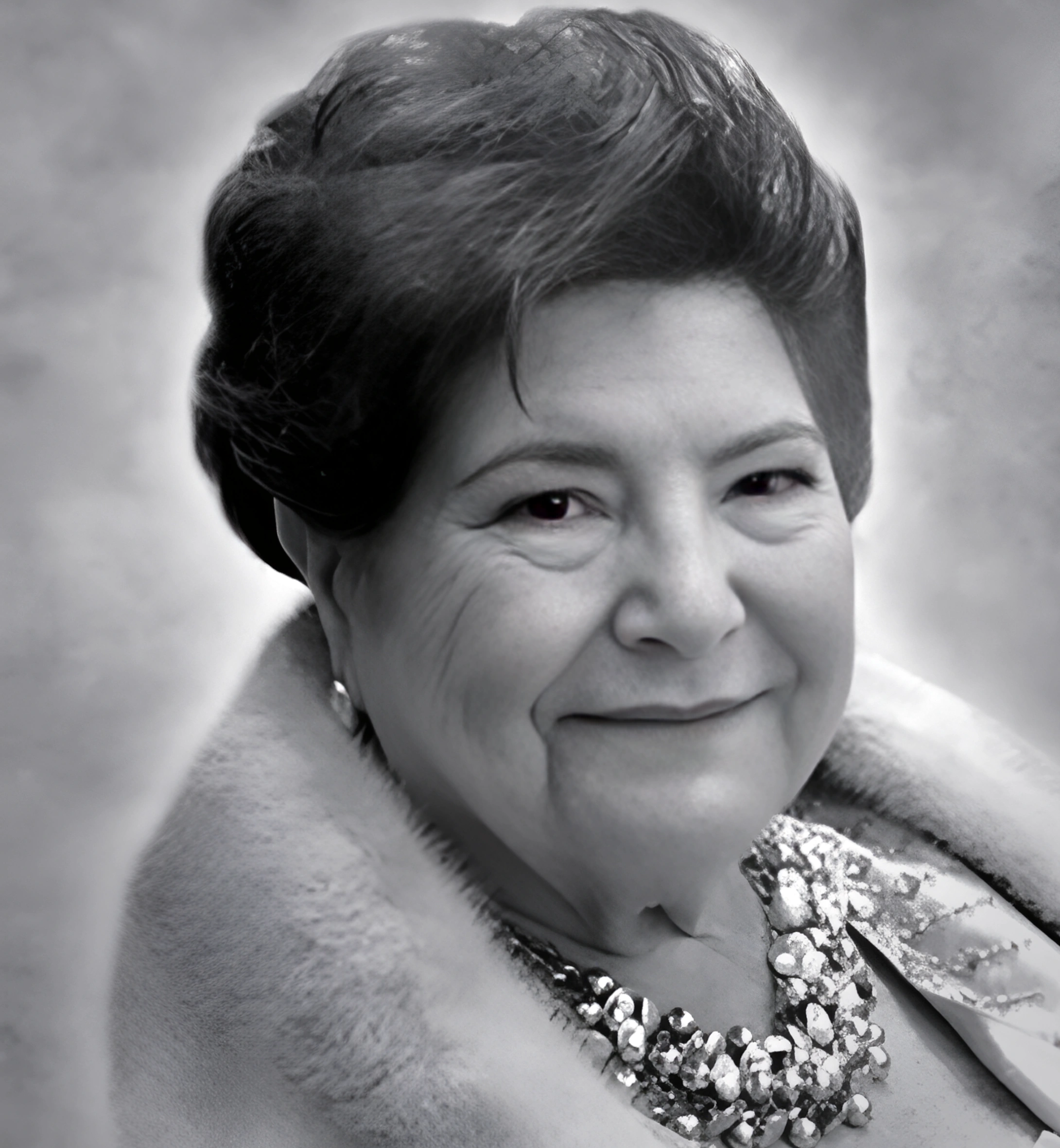 Smiling elderly woman with a sequined bow and fur coat.