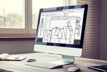 Computer screen displaying fashion design software with clothing patterns.