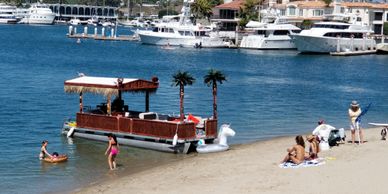 TikiFunBoats pontoon boat rental allows for docking up the Big Bamboo at the Newport harbor beach 