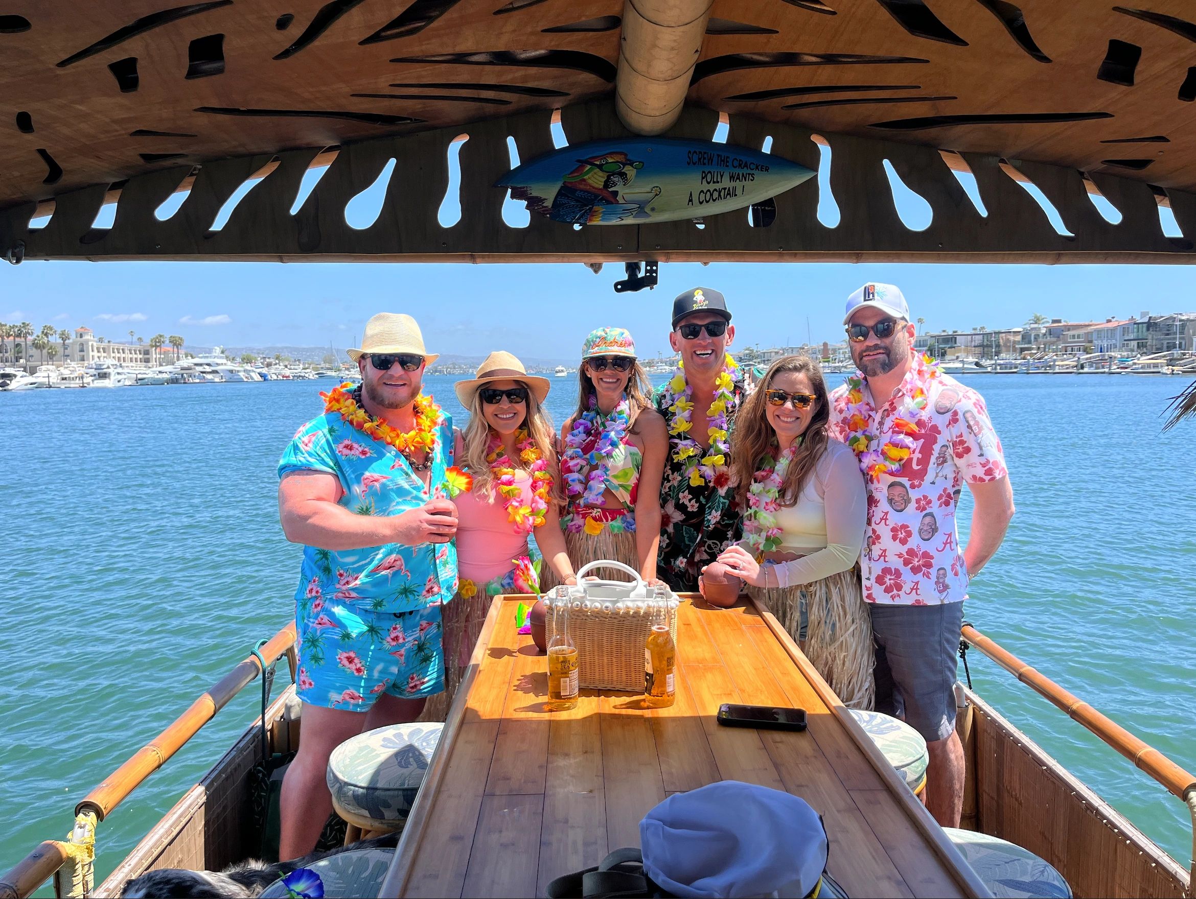A happy group of customers aboard our Newport Tiki Boat on a sunny summer day.