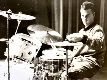 Mito Mora sentado en una batería ajustando el hi-hat