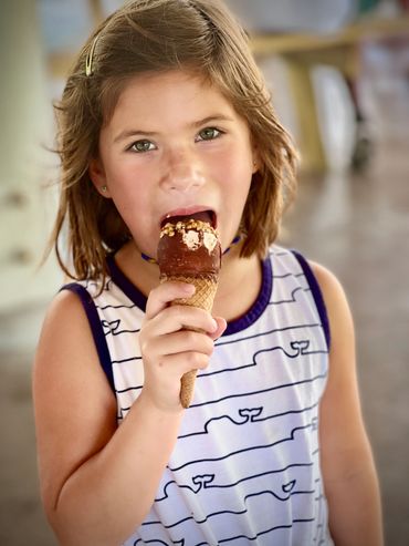 Girl eating Karmic Ice Cream cone from Karmic Ice Cream cart in Miami 