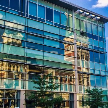Reflection of the courthouse in the Commons glass. Photo credit: Don Nissan. 